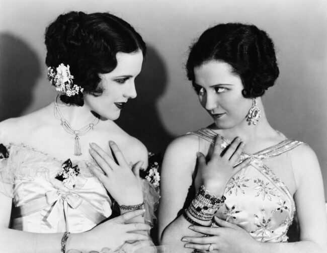 Two women place their hands of their collarbone and look curiously at each other about forgotten female investors ..